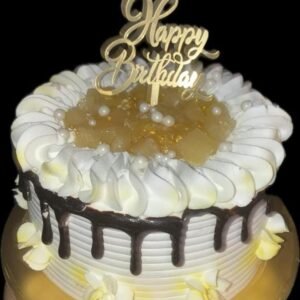 Pineapple cream birthday cake with chocolate drip and whipped frosting