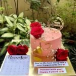 Customized birthday cake with photo toppers, red roses and golden decoration