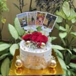 Customized birthday cake with photo toppers, red roses and golden decoration