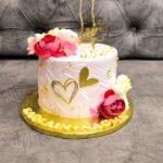 Customized anniversary cake with heart design, flowers and golden decoration